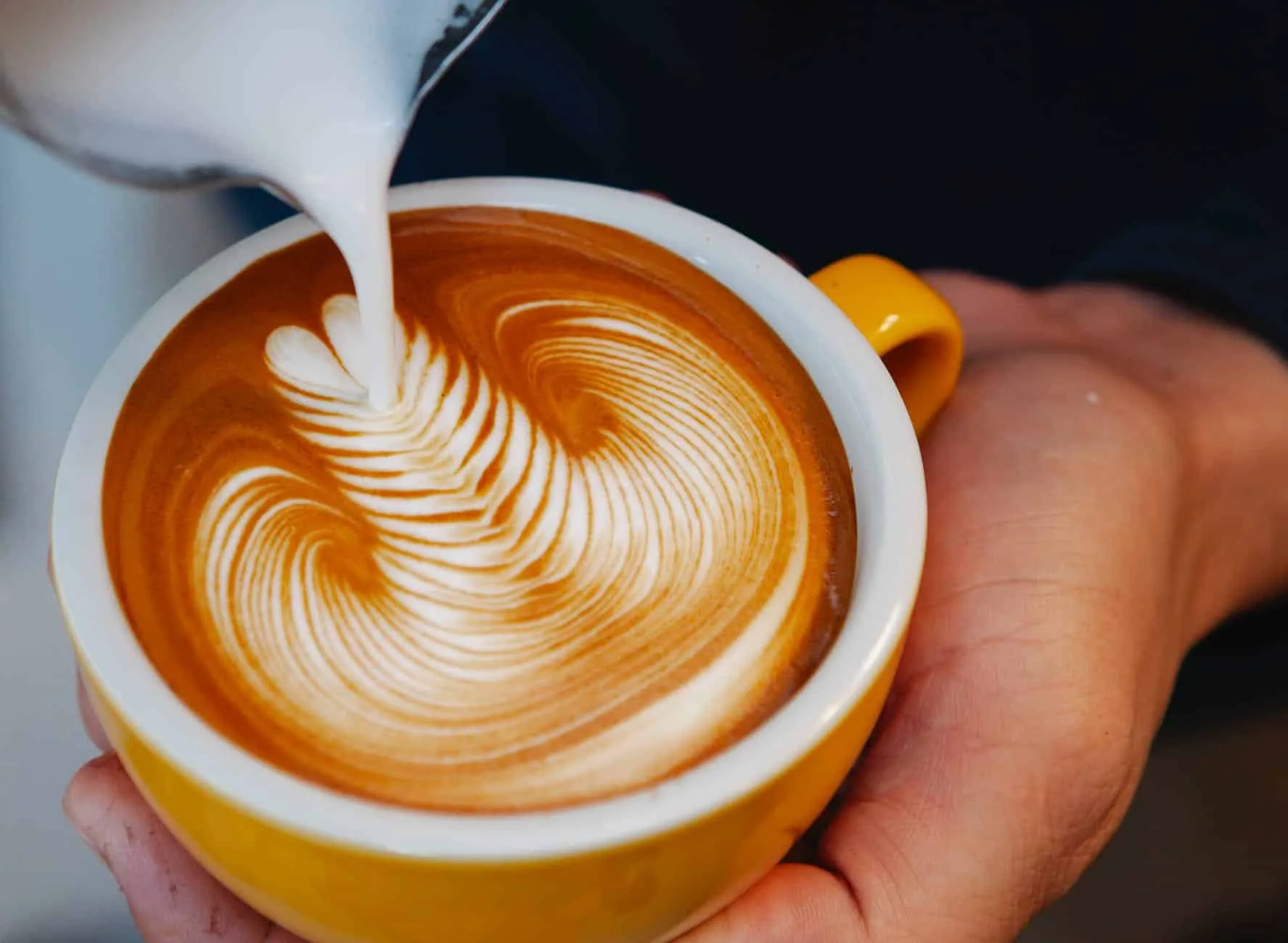 crop barista making latte art