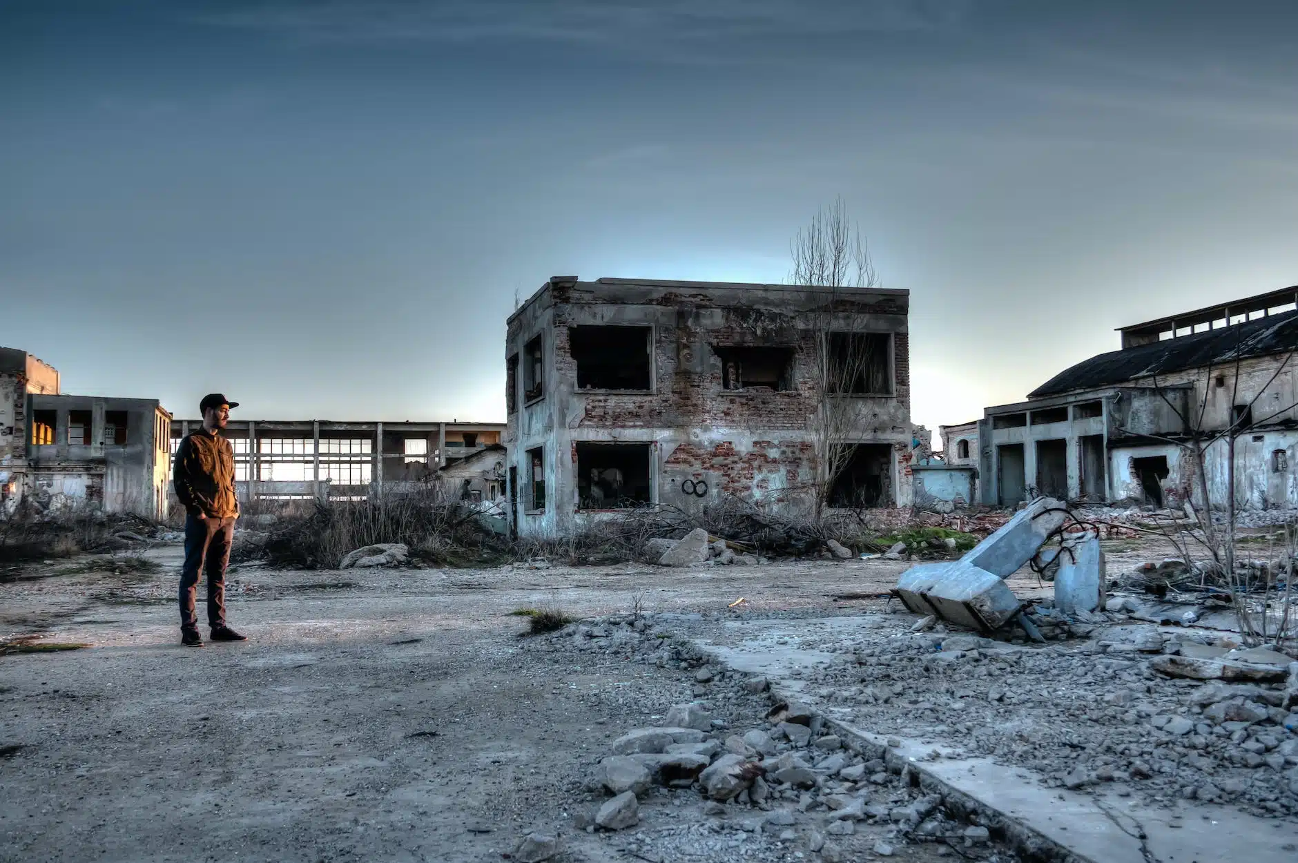 man standing near ruined buildings