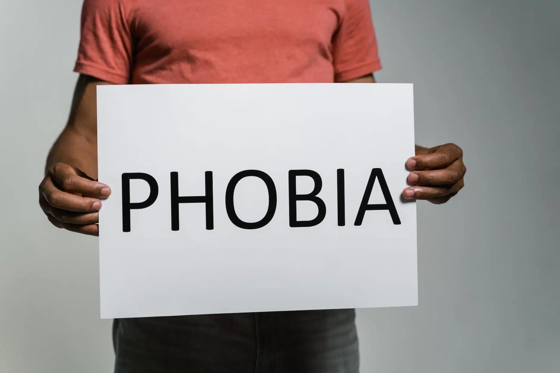 a person holding a sign of phobia