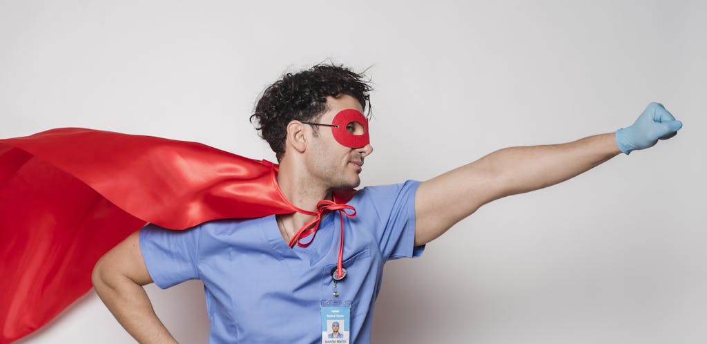 Brave doctor in flying superhero cape with fist stretched