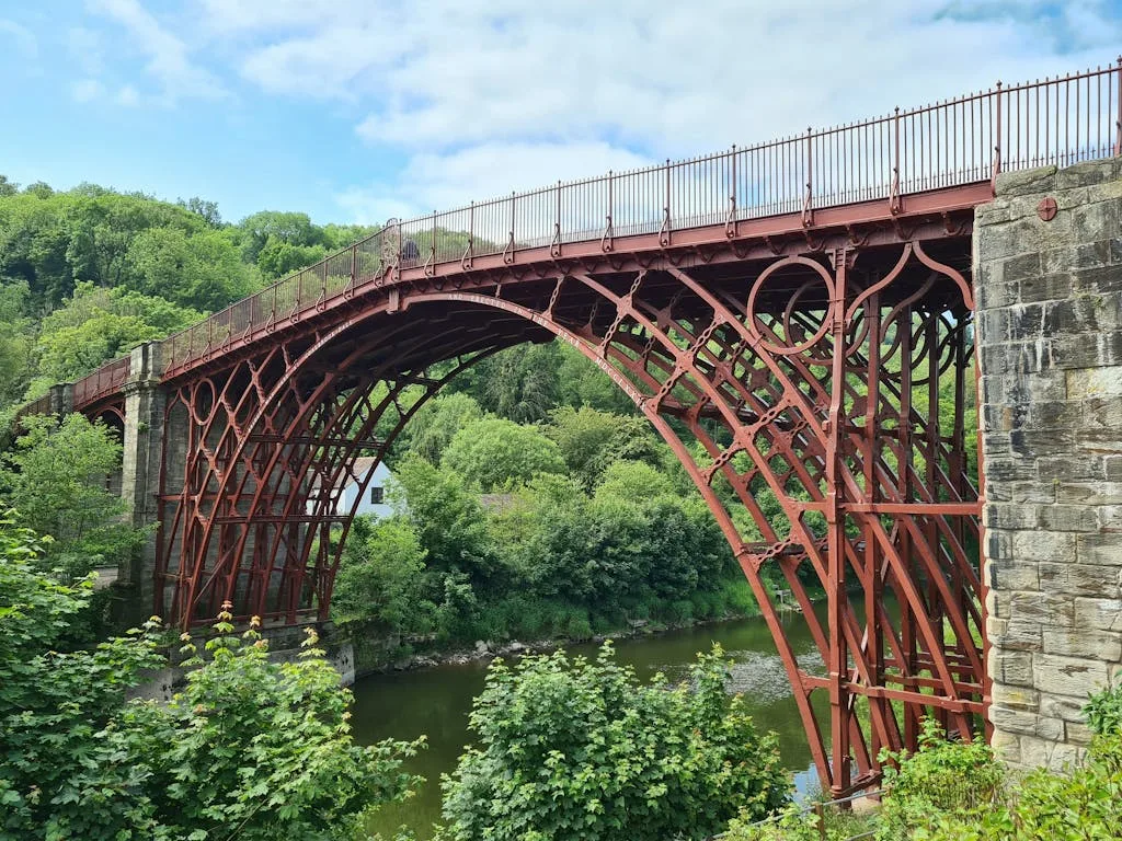 Capture of the iconic Iron Bridge in Ironbridge, England, showcasing its historic design amid lush surroundings.